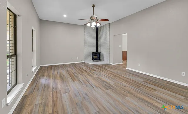 wooden floor in an empty room with a window