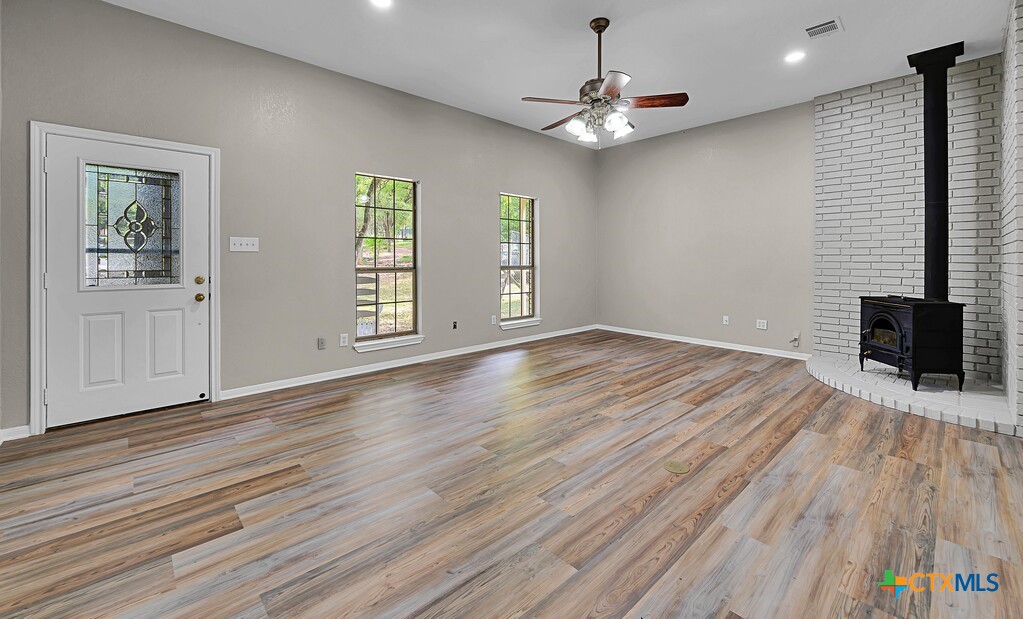 3900 Fox Ridge Road Lorena, TX 76655 - Photo 4 of 35 a view of an empty room with wooden floor and a window