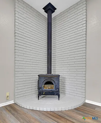 a view of a livingroom with wooden floor and a potted plant