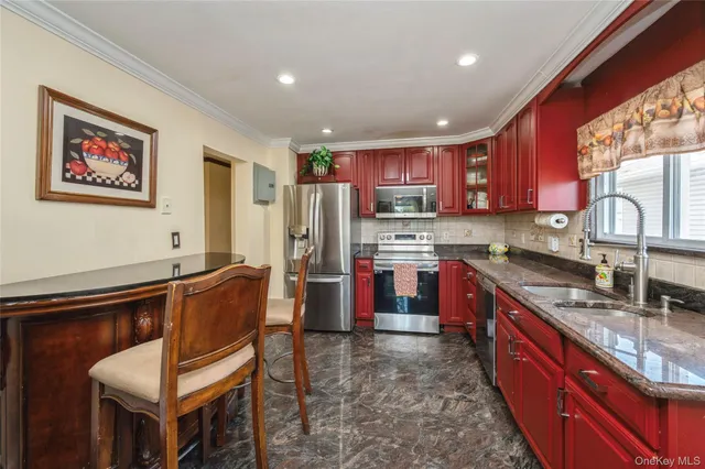 a kitchen with stainless steel appliances granite countertop a refrigerator sink and wooden cabinets