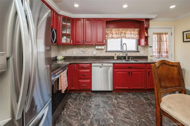 a kitchen with stainless steel appliances granite countertop a refrigerator sink and wooden cabinets
