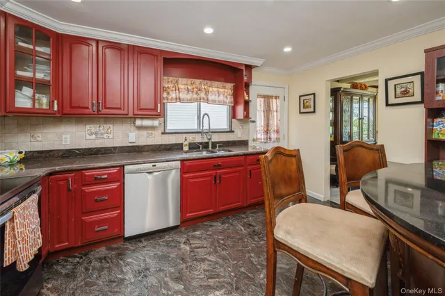 a kitchen with stainless steel appliances granite countertop a sink a stove cabinets dining table and chairs