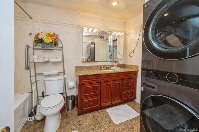 a bathroom with a toilet a sink and mirror