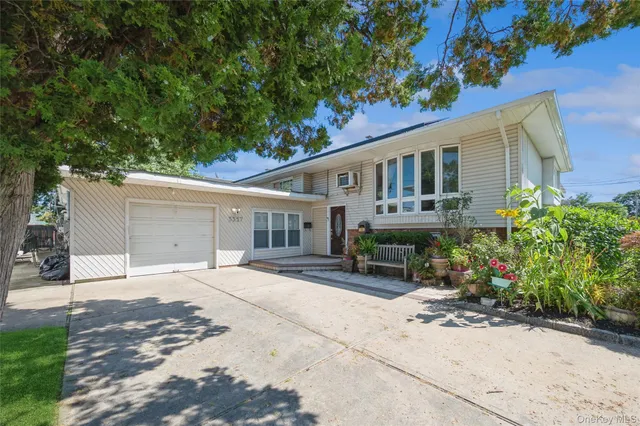 a house view with a sitting space and garden space