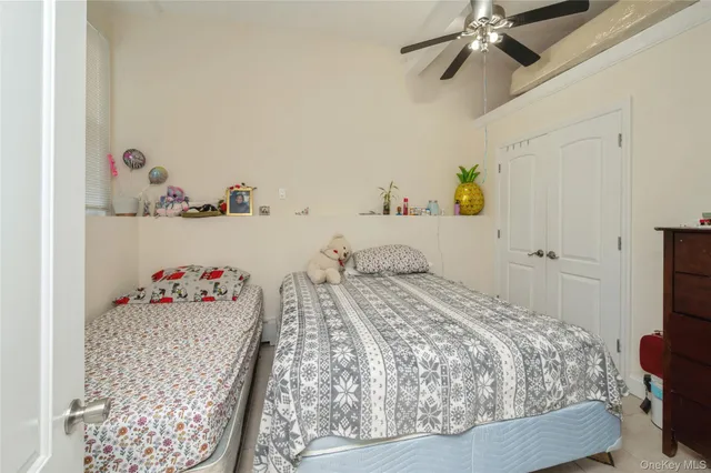 a bedroom with a bed and ceiling fan