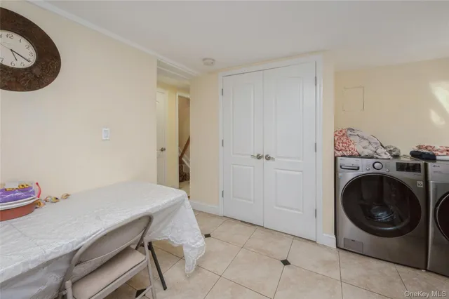 a view of a storage and utility room with washer and dryer