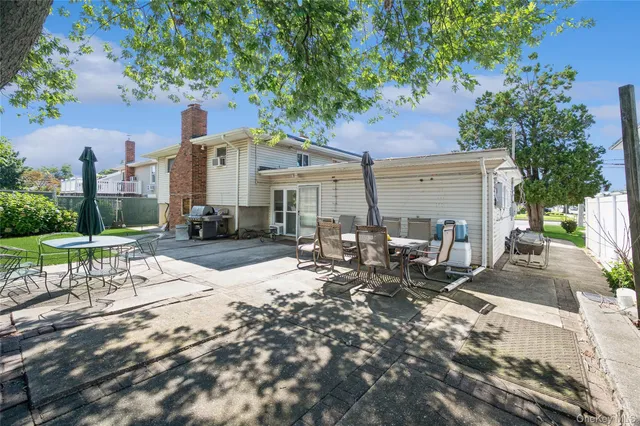 a row of palm trees in front of a house
