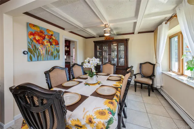 a dining room with furniture a rug and a window