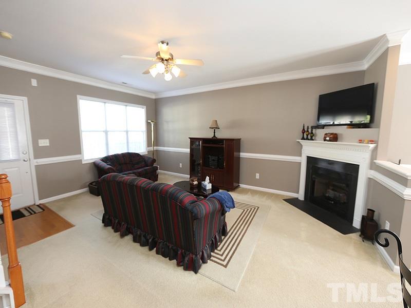 2715 Andover Glen Road Raleigh, NC 27604 - Photo 3 of 16 a living room with furniture and a flat screen tv