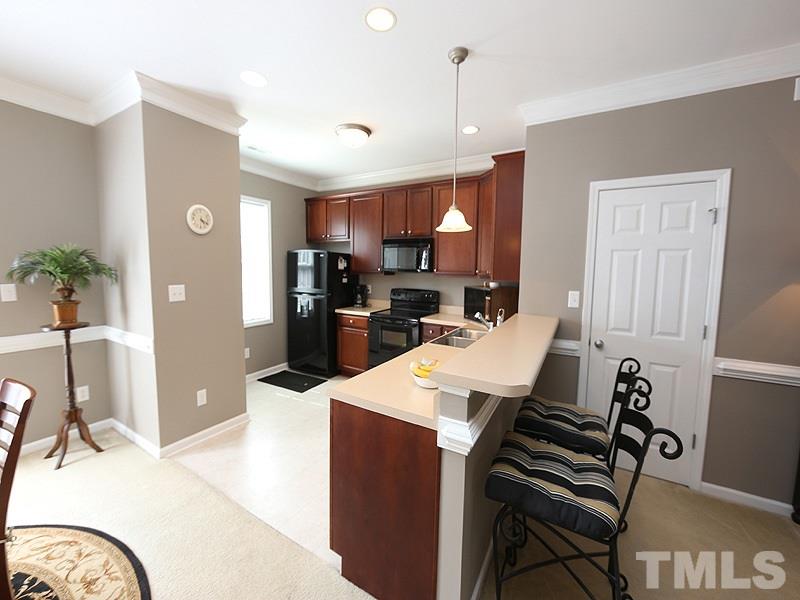 2715 Andover Glen Road Raleigh, NC 27604 - Photo 5 of 16 a kitchen with a table and chairs in it