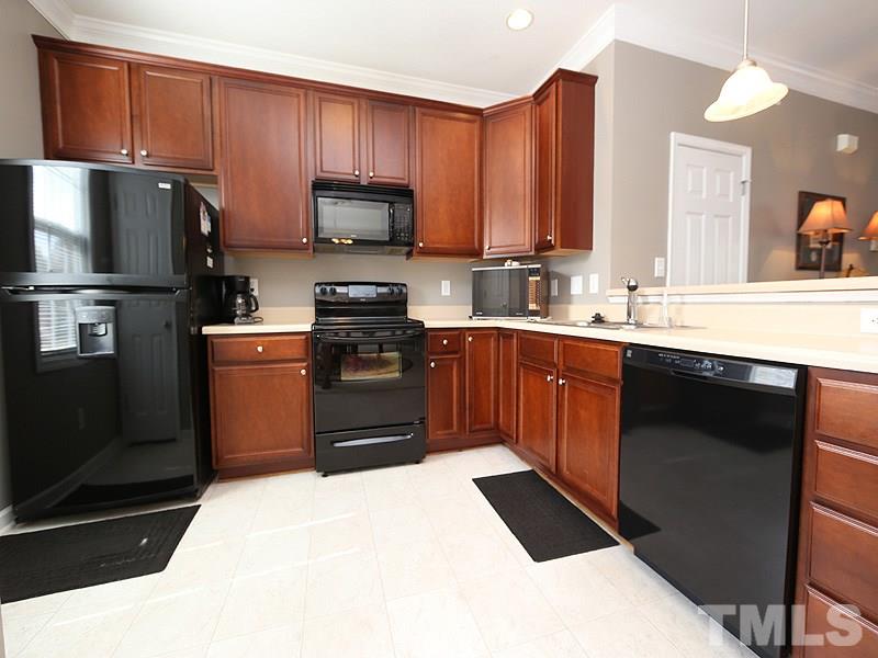 2715 Andover Glen Road Raleigh, NC 27604 - Photo 6 of 16 a kitchen with stainless steel appliances granite countertop a sink stove and refrigerator