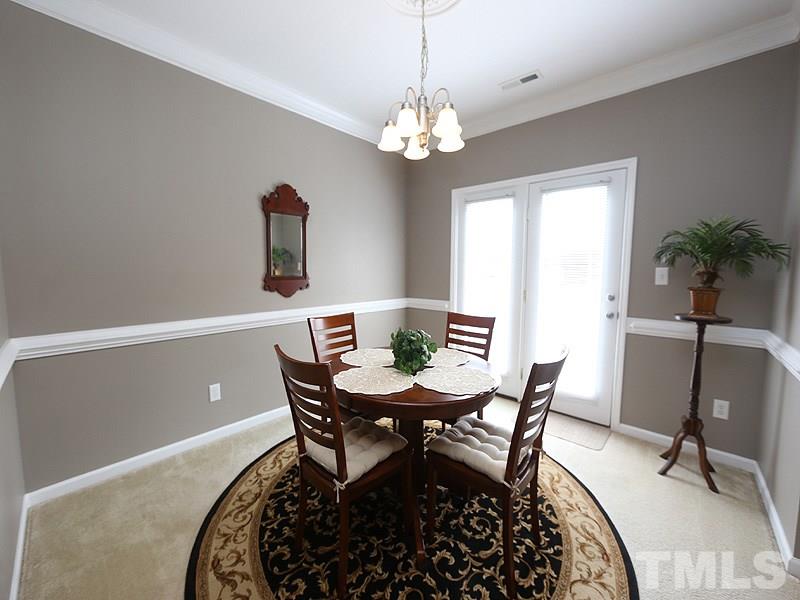 2715 Andover Glen Road Raleigh, NC 27604 - Photo 7 of 16 a view of a dining room with furniture and chandelier