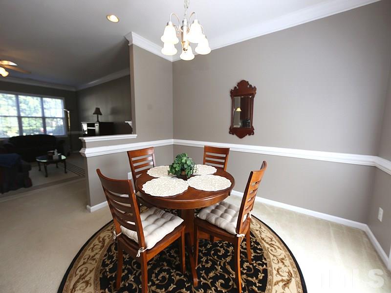 2715 Andover Glen Road Raleigh, NC 27604 - Photo 8 of 16 a view of a dining room with furniture and chandelier