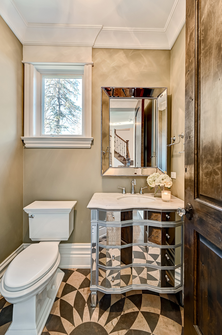 359 Ruby Street Clarendon Hills, IL 60514 - Photo 22 of 45 a bathroom with a sink a toilet and mirror