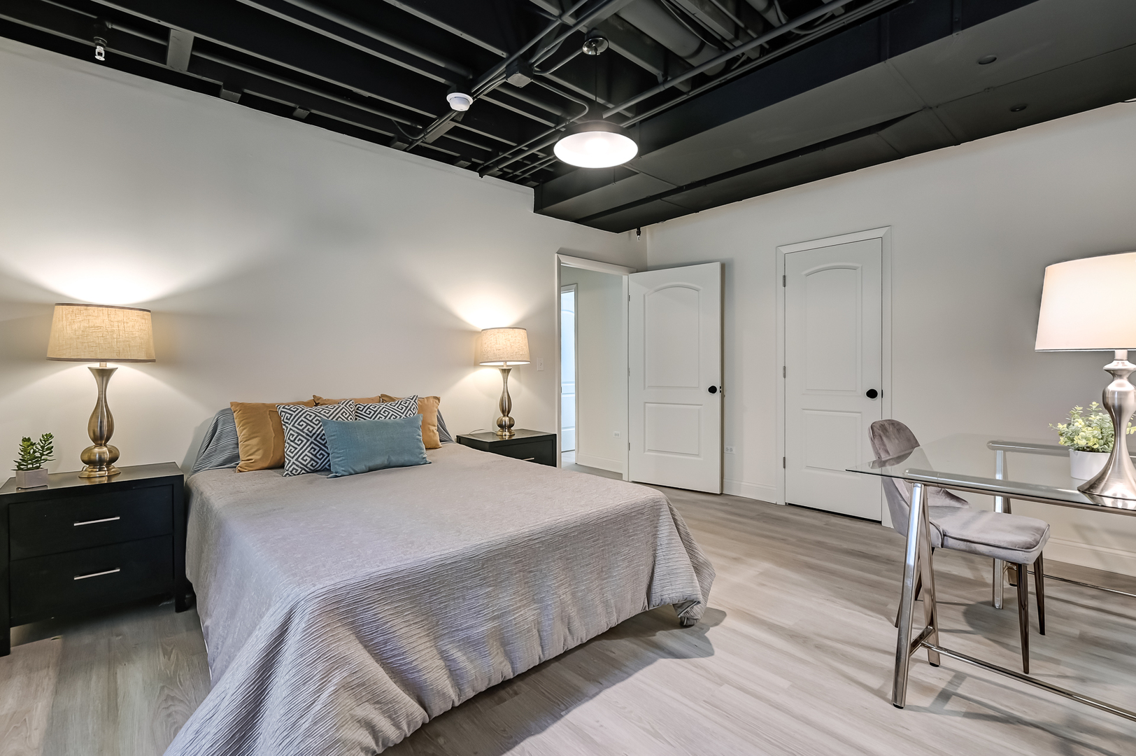 359 Ruby Street Clarendon Hills, IL 60514 - Photo 35 of 45 a spacious bedroom with a bed a desk and chair with wooden floor