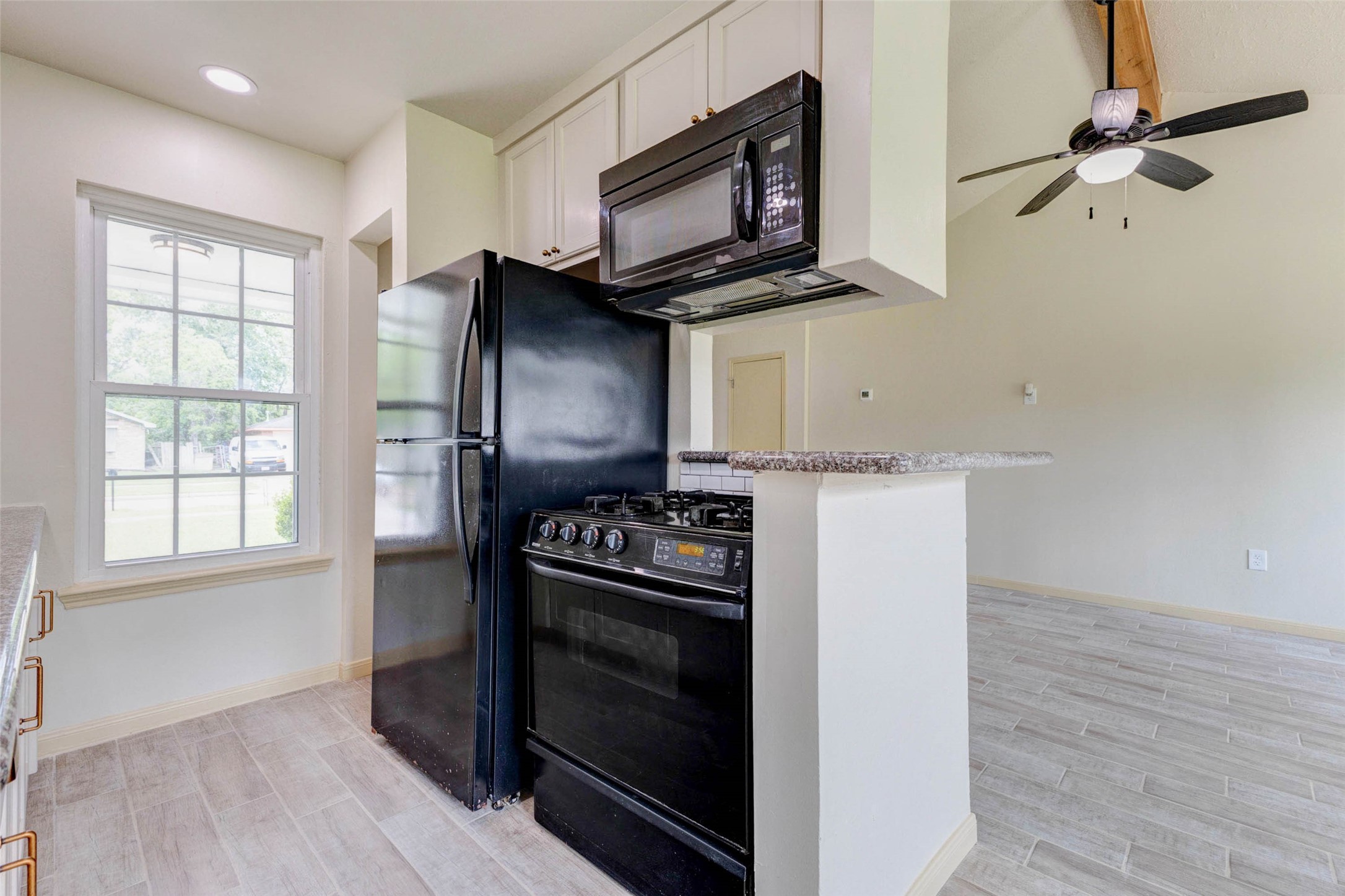 5319 Ridgestone Street Houston, TX 77053 - Photo 12 of 26 a kitchen with a stove and a microwave