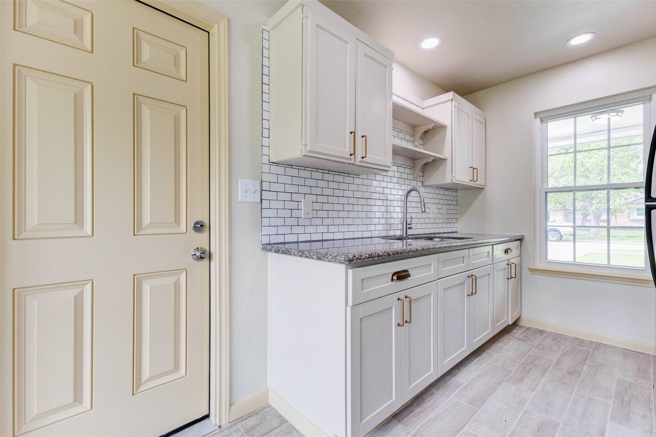 5319 Ridgestone Street Houston, TX 77053 - Photo 13 of 26 a kitchen with granite countertop white cabinets and white appliances