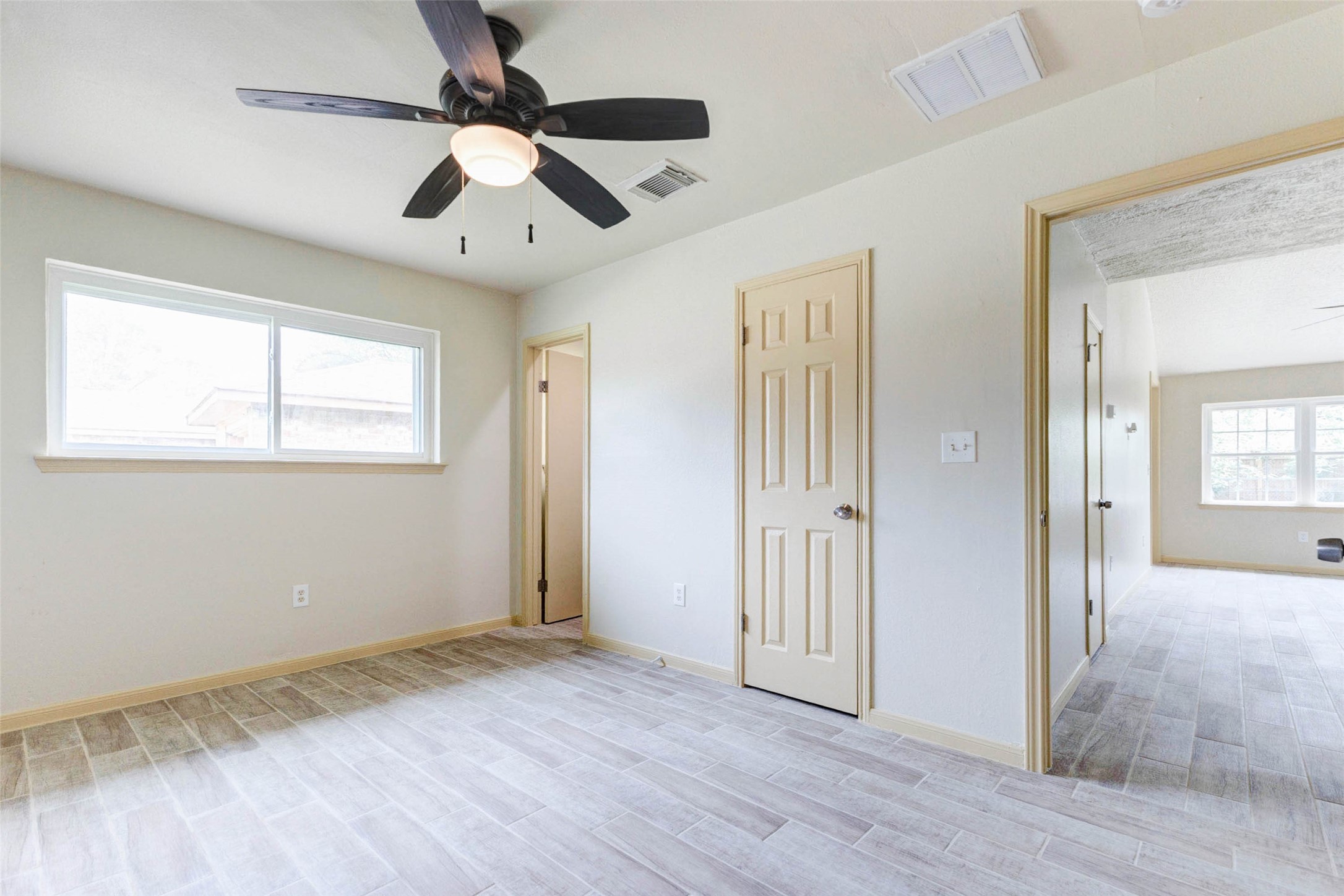 5319 Ridgestone Street Houston, TX 77053 - Photo 17 of 26 an empty room with wooden floor a ceiling fan and closet