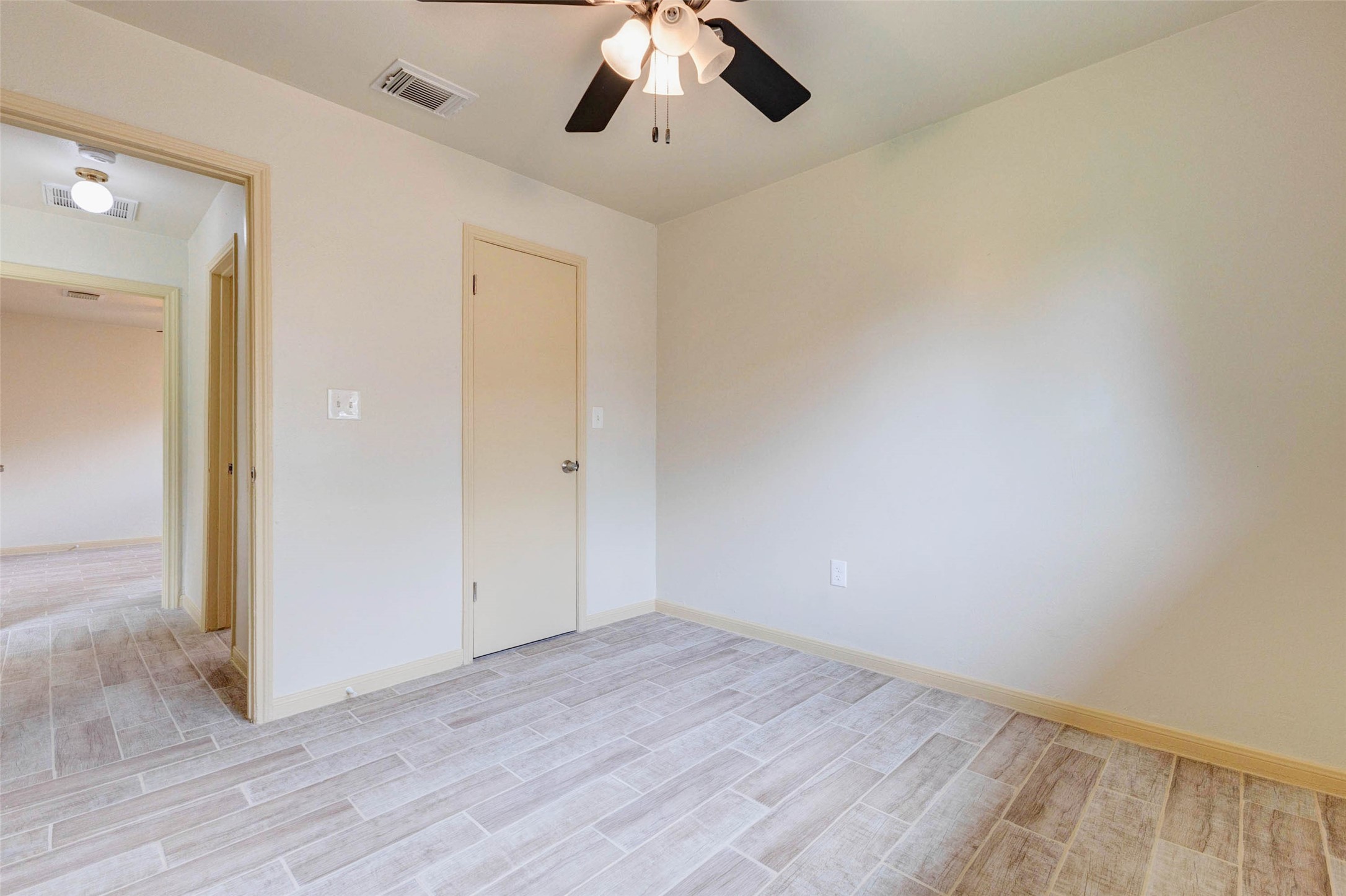 5319 Ridgestone Street Houston, TX 77053 - Photo 22 of 26 an empty room with a ceiling fan and wooden floor
