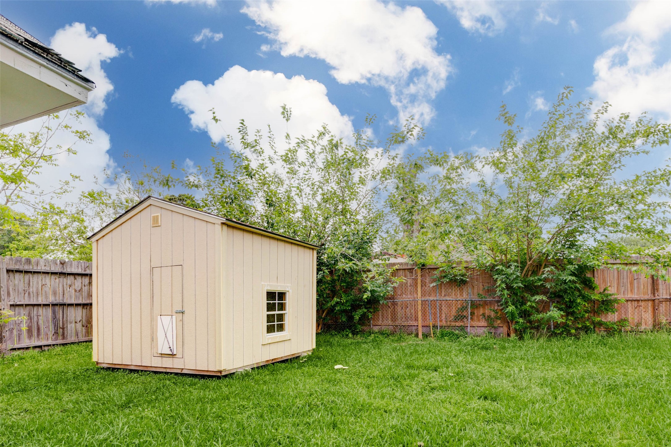 5319 Ridgestone Street Houston, TX 77053 - Photo 26 of 26 a white house with a small yard and large trees