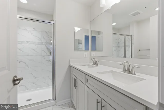 a bathroom with a shower sink and mirror