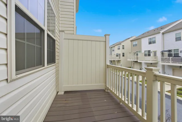 a view of a balcony with wooden floor and fence