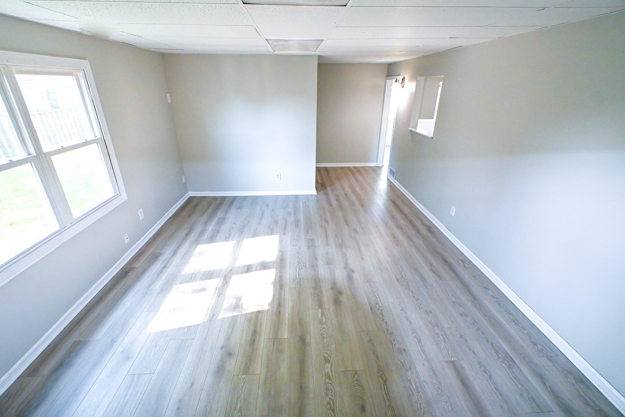 7828 Chestnut Avenue Hammond, IN 46324 - Photo 17 of 23 a view of empty room with wooden floor and fan