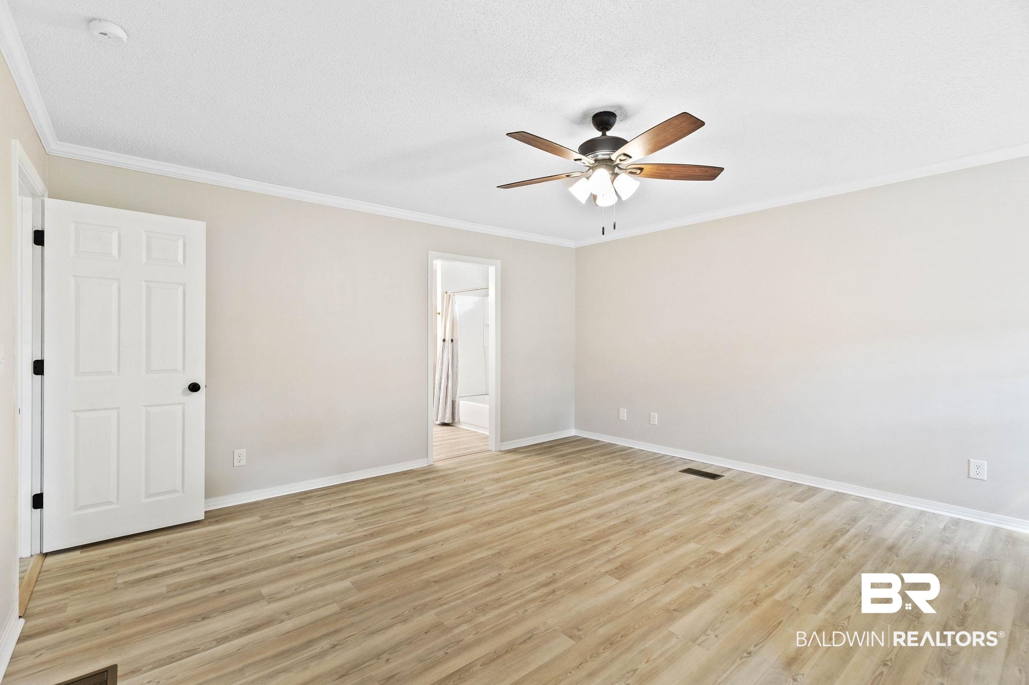 35650 Spring Road North Stapleton, AL 36578 - Photo 36 of 70 Unfurnished bedroom with crown molding, light wood-style flooring, and a ceiling fan