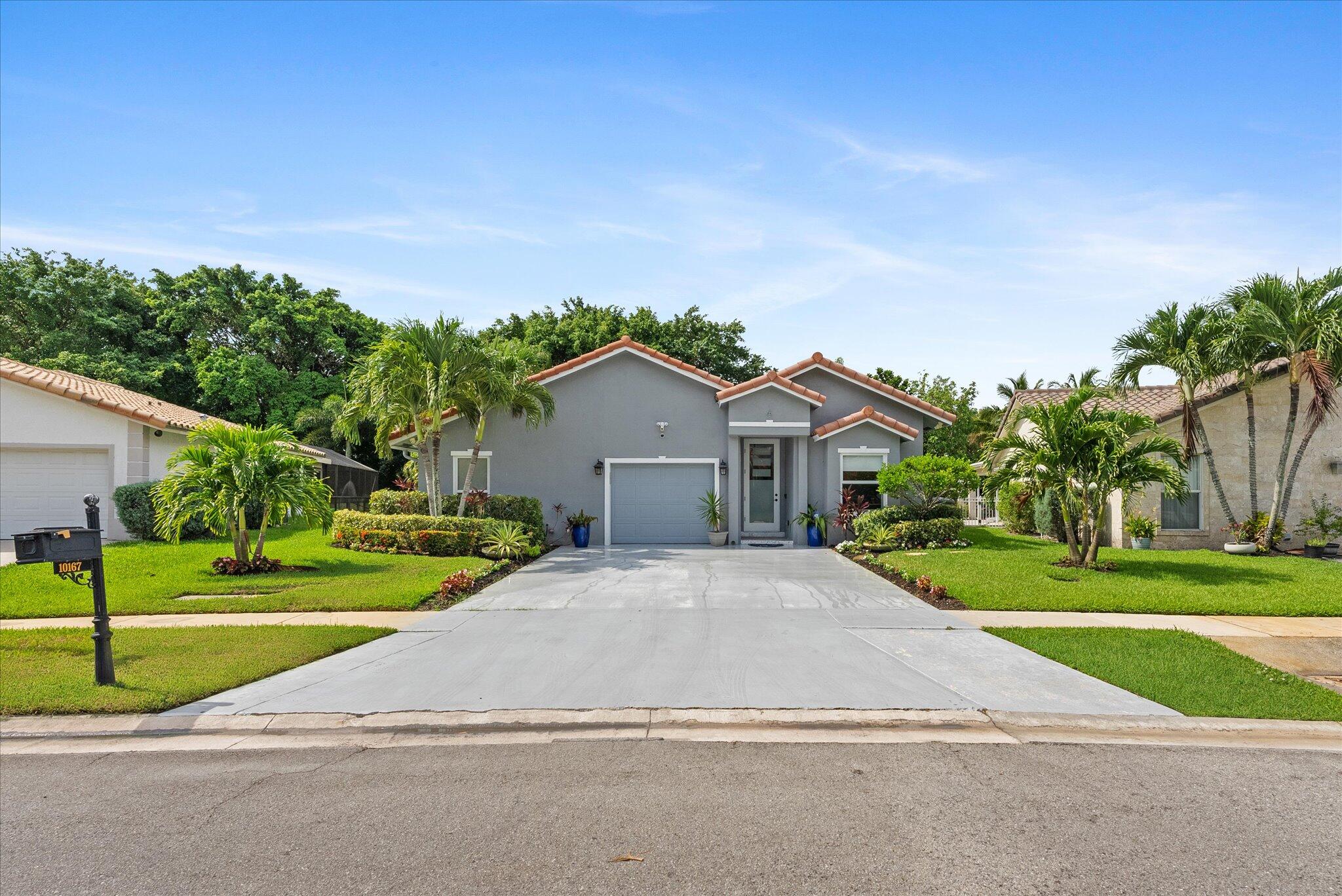 10167 Camelback Lane Boca Raton, FL 33498 - Photo 1 of 55 a view of a house with a yard and large trees