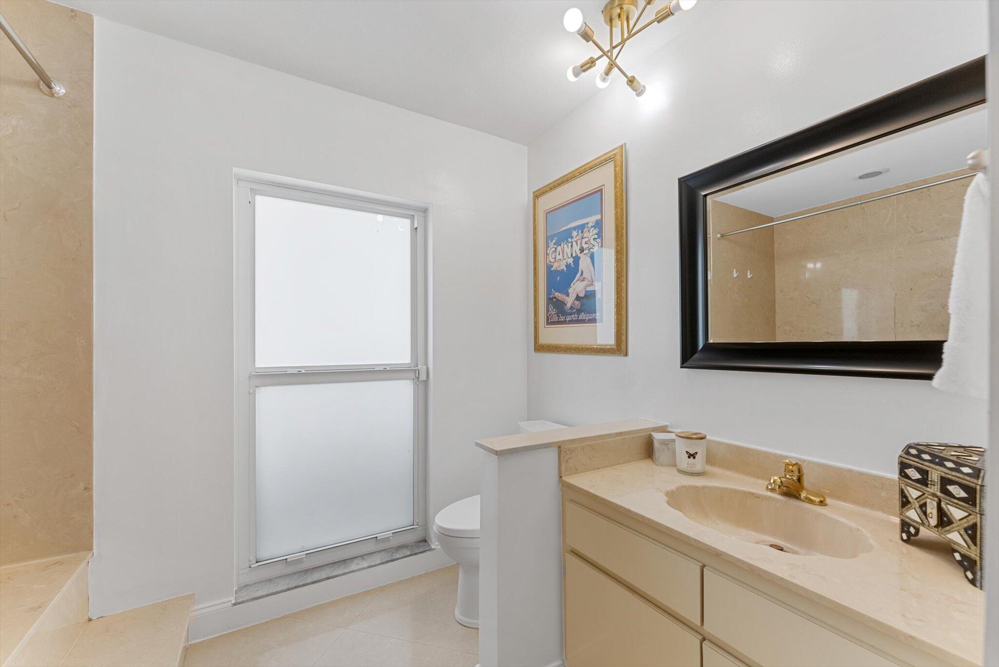 10167 Camelback Lane Boca Raton, FL 33498 - Photo 19 of 55 a bathroom with a toilet sink and mirror