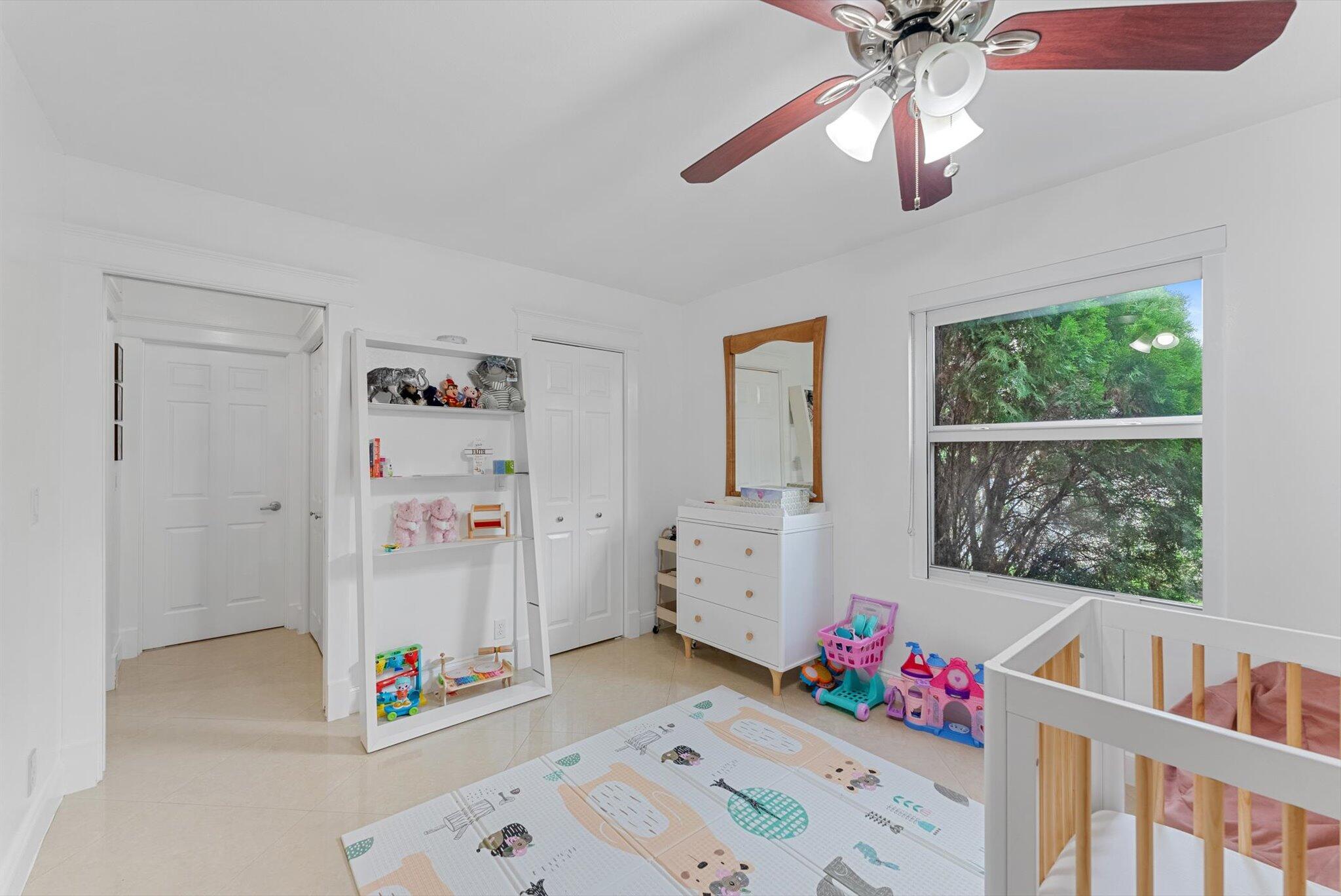 10167 Camelback Lane Boca Raton, FL 33498 - Photo 20 of 55 a living room with furniture and a baby crib