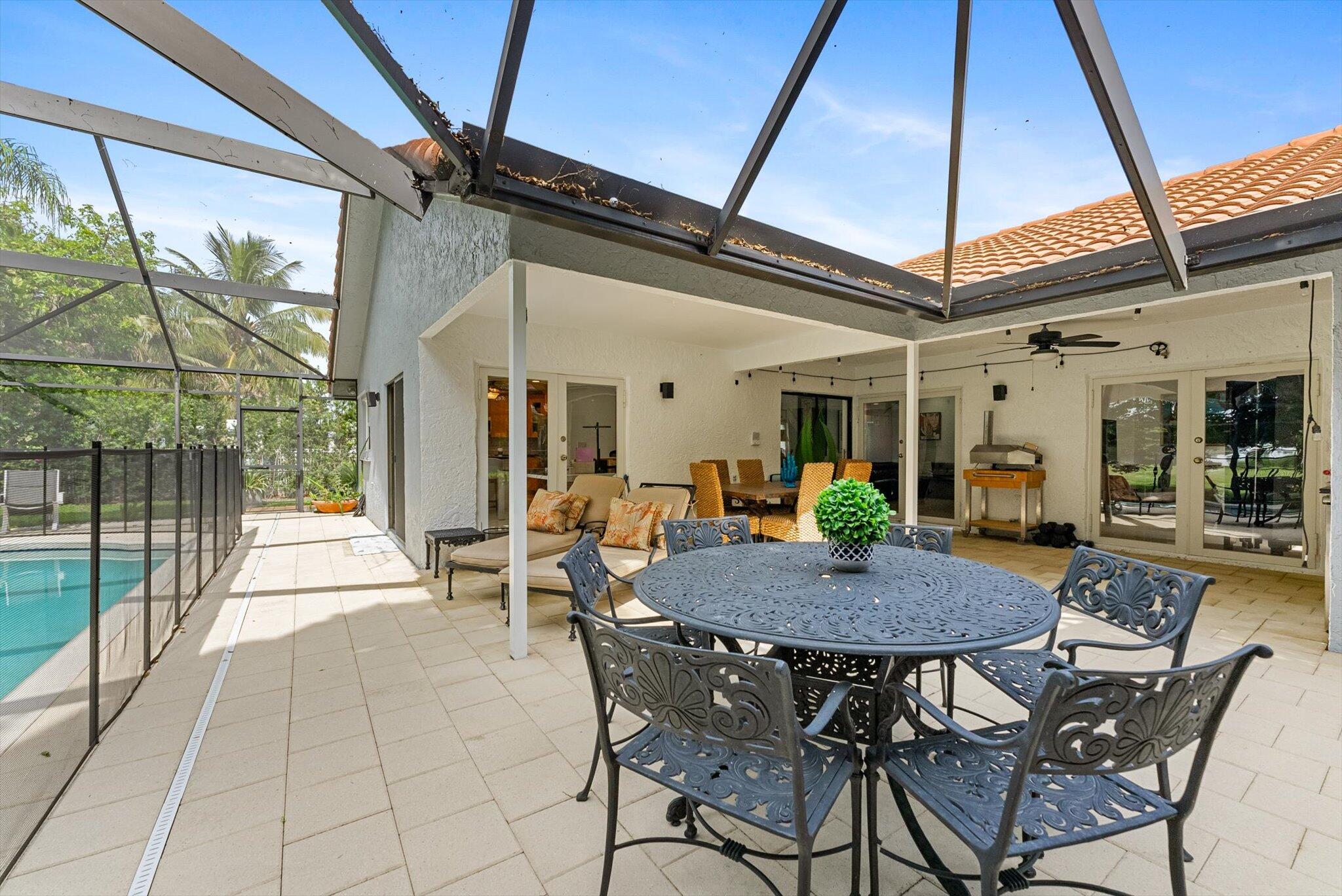 10167 Camelback Lane Boca Raton, FL 33498 - Photo 28 of 55 a view of a dining table and chairs in the patio