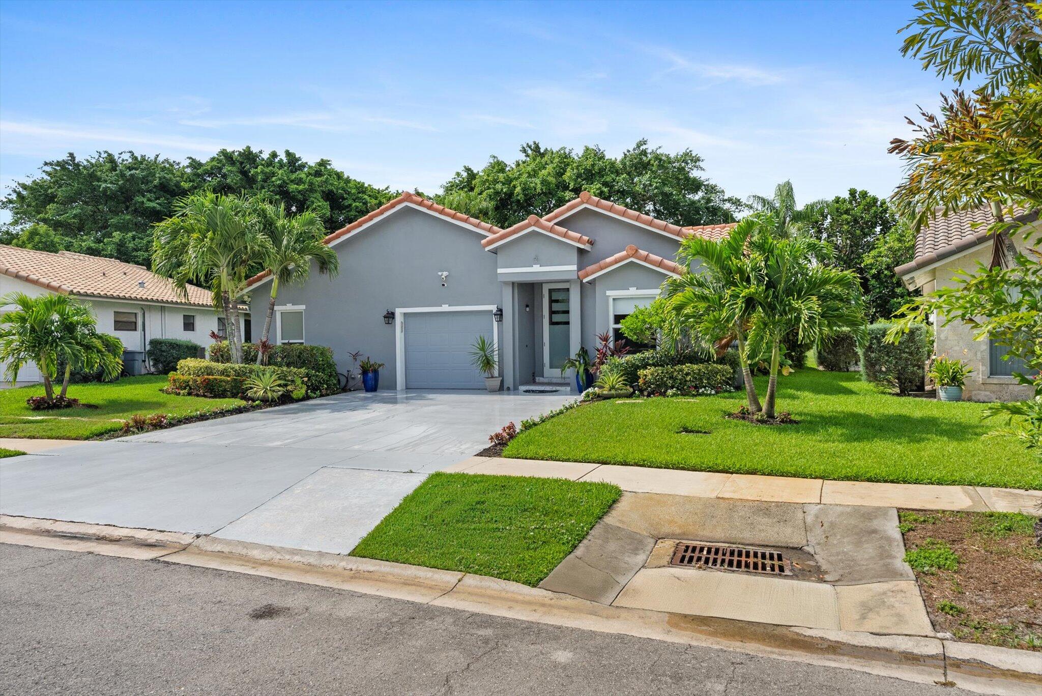 10167 Camelback Lane Boca Raton, FL 33498 - Photo 35 of 55 front view of a house with a yard