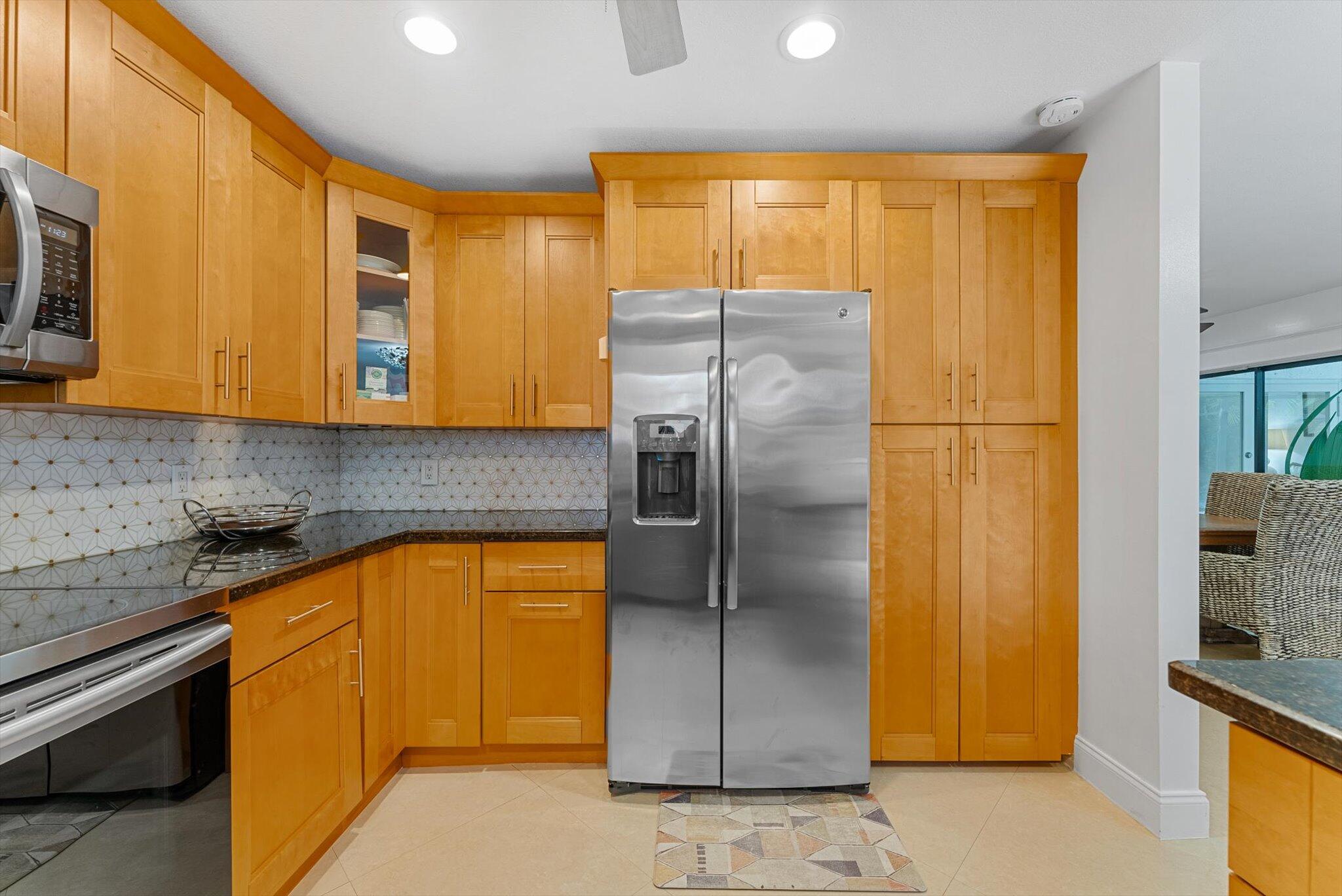 10167 Camelback Lane Boca Raton, FL 33498 - Photo 6 of 55 a kitchen with stainless steel appliances granite countertop a refrigerator a stove and a sink