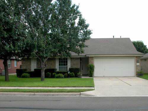 6420 Colton-Bluff Springs Road Austin, TX 78744 - Photo 1 of 1 a front view of a house with a garden and plants