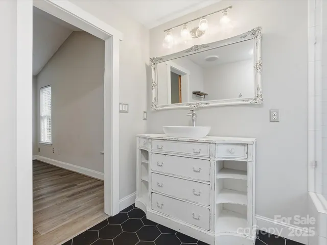 a bathroom with a sink vanity and mirror