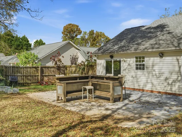 a view of a house with a wooden fence