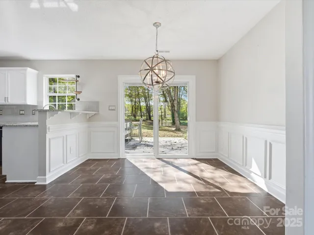 a view of a room with windows and chandelier