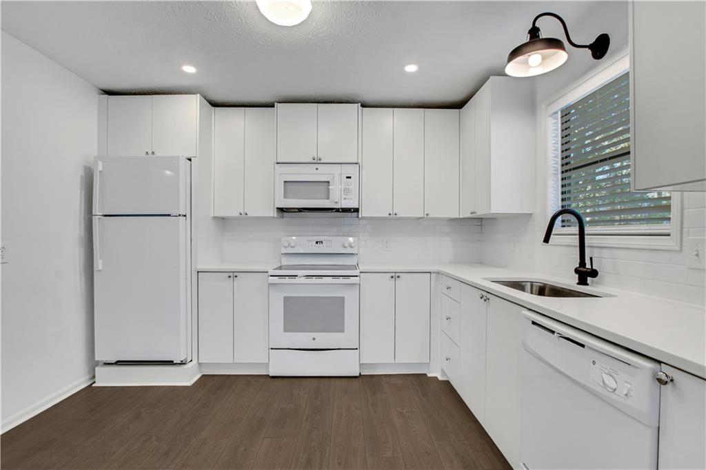 1000 Mathews Court, Unit B Smyrna, GA 30080 - Photo 17 of 42 a kitchen with stainless steel appliances a refrigerator sink and stove