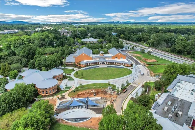 an aerial view of a house with swimming pool outdoor seating and yard
