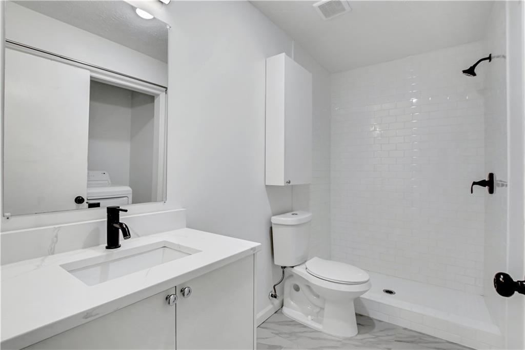 1000 Mathews Court, Unit B Smyrna, GA 30080 - Photo 27 of 42 a bathroom with a sink a toilet and shower