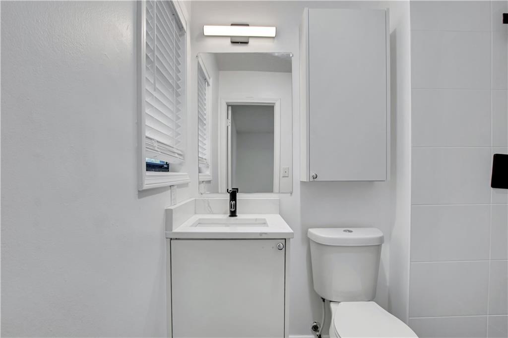 1000 Mathews Court, Unit B Smyrna, GA 30080 - Photo 29 of 42 a bathroom with a sink toilet and mirror