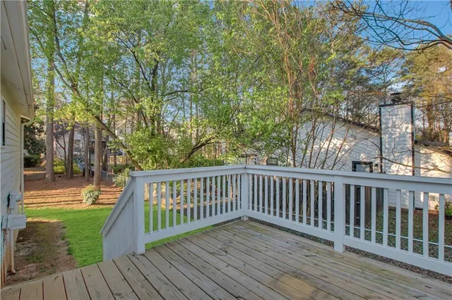 a view of balcony with wooden floor and fence