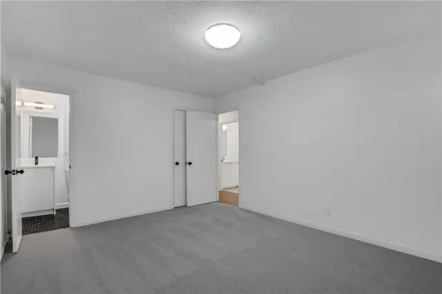 a view of an empty room and a window