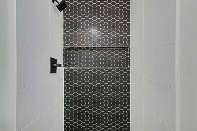 a bathroom with a black white checkered floor