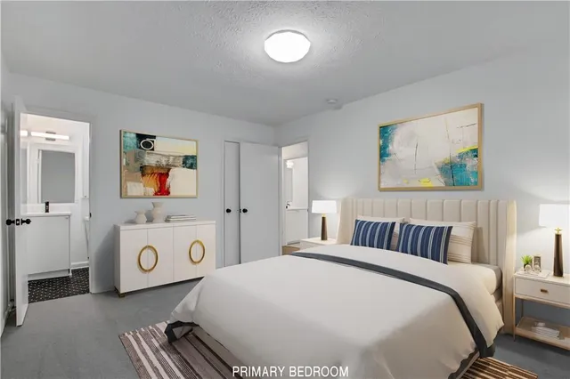 a bedroom with a bed and a painting on the wall