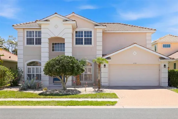 a front view of a house with a yard garage and outdoor seating