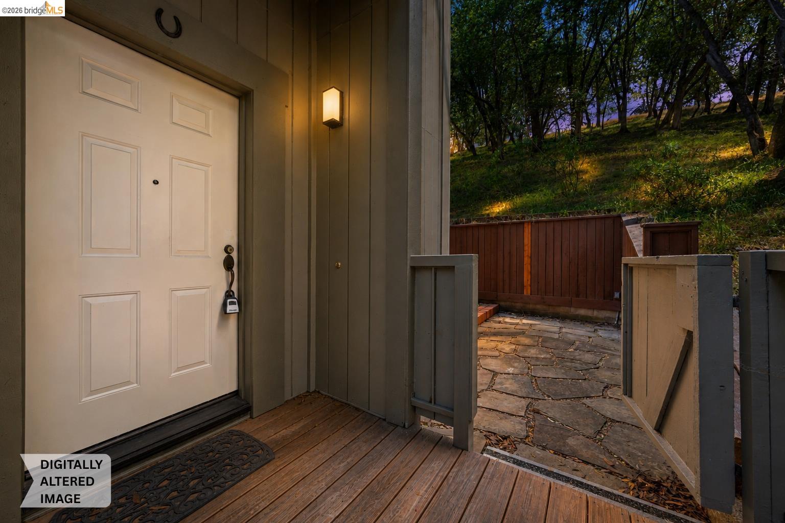 261 Redhawk Road Novato, CA 94949 - Photo 10 of 47 Entryway featuring a paneled door, exterior wall lighting, and natural wood decking
