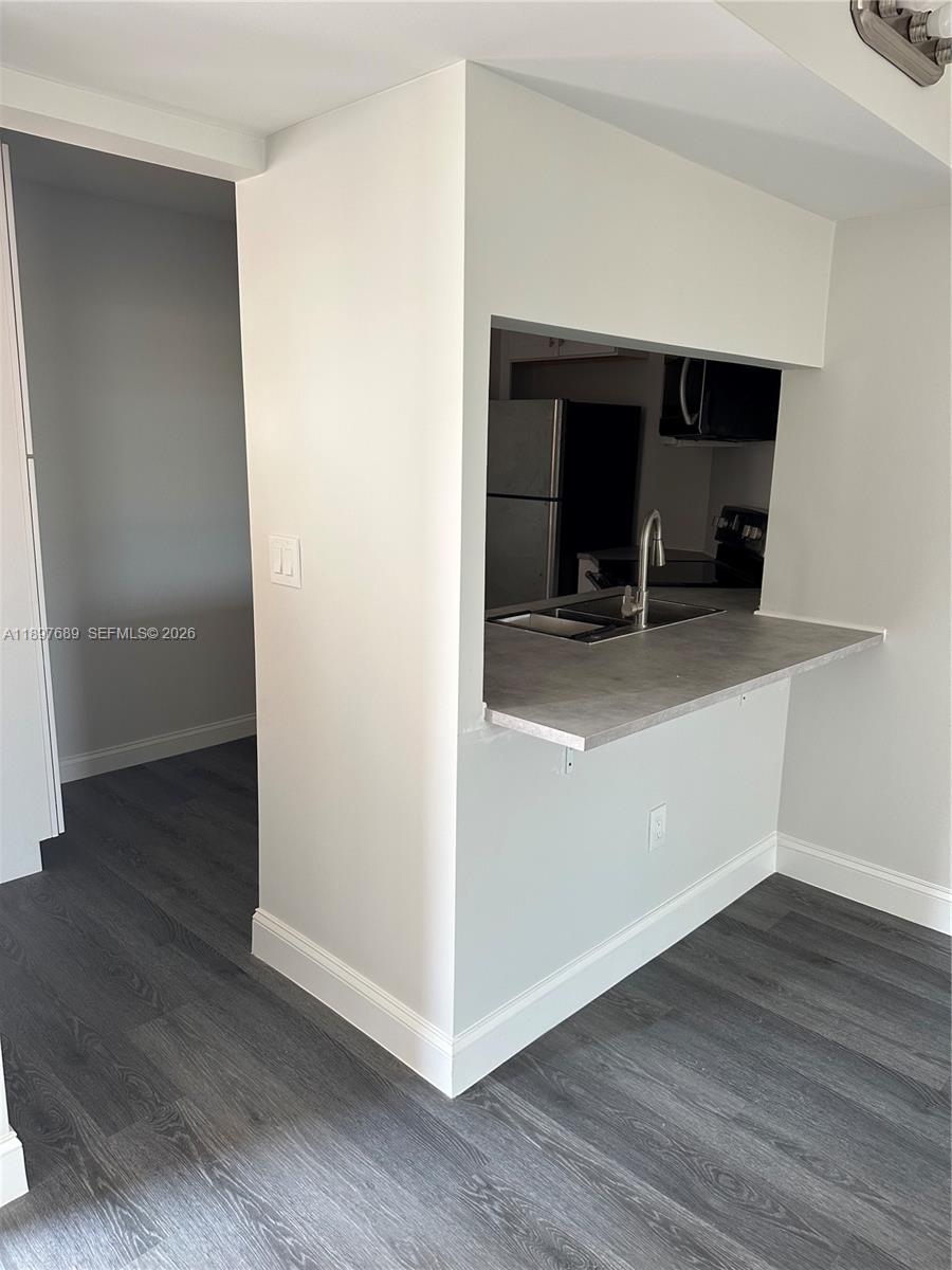 855 Northeast 209th Street, Unit 10334 Miami, FL 33179 - Photo 19 of 38 a view of a workspace with wooden floor