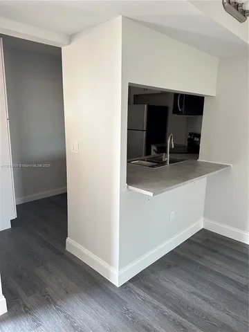 a view of a workspace with wooden floor